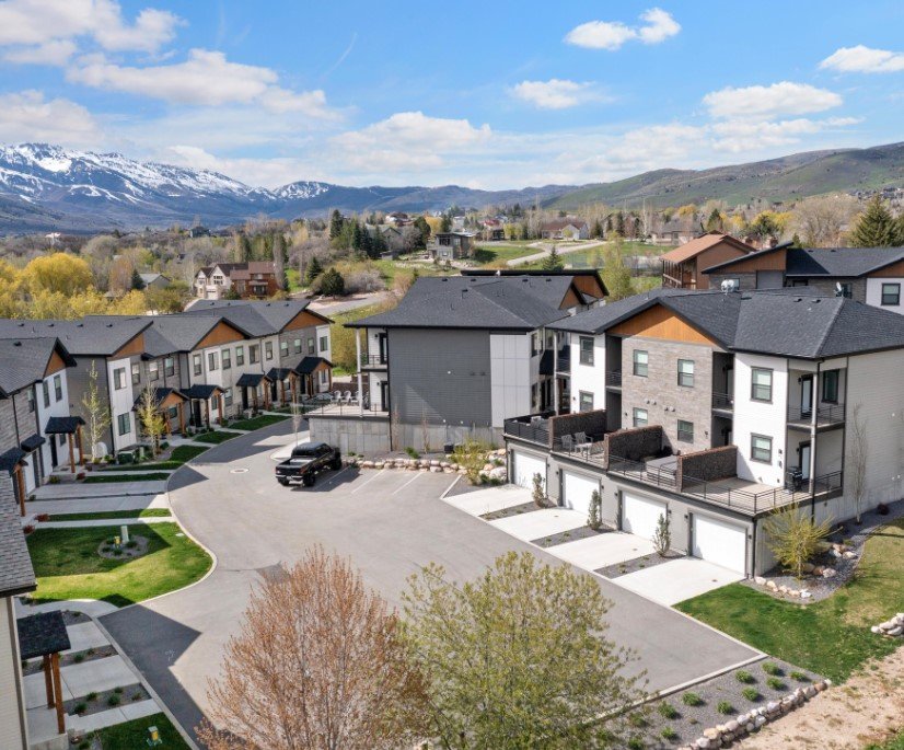 Rear view of house featuring a residential view, a mountain view, and a patio area