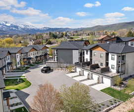 Rear view of house featuring a residential view, a mountain view, and a patio area