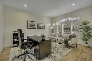 Office area with recessed lighting and light wood-style floors