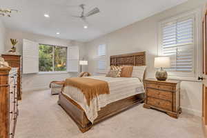 Main Level Primary Bedroom featuring a ceiling fan, recessed lighting, and light carpet