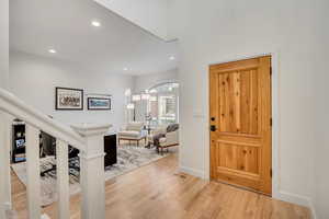 Foyer featuring light wood finished floors and recessed lighting