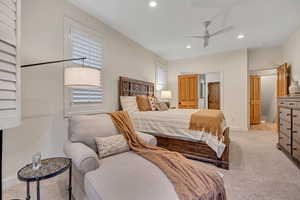 Main Level Primary Bedroom featuring recessed lighting, carpet floors, and a ceiling fan