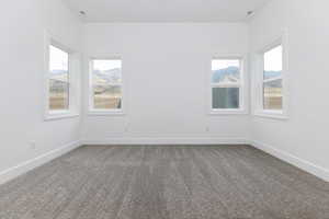 Unfurnished room featuring carpet flooring and baseboards