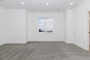 Spare room with recessed lighting and light colored carpet