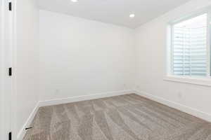 Unfurnished room with carpet flooring and recessed lighting