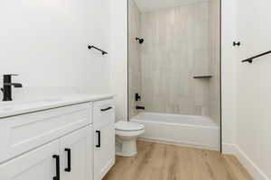 Full bathroom featuring vanity, light wood-style floors, and shower / bathtub combination