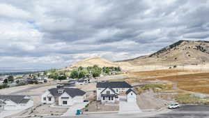 View of mountain backdrop featuring nearby suburban area