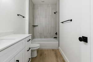 Full bath featuring light wood-style floors, vanity, and shower / bathtub combination
