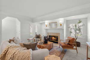 Large living room has high ceilings and fireplace