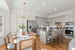 Kitchen has barstool seating and room for a breakfast table and chairs