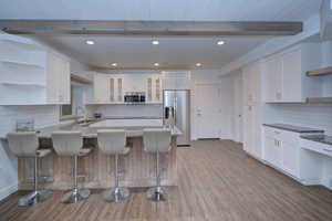 Kitchen featuring open shelves, tasteful backsplash, white cabinets, recessed lighting, and beam ceiling