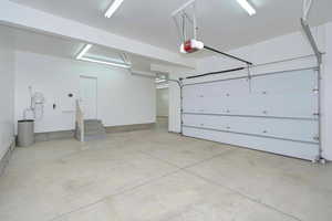 Garage with a garage door opener and a central vacuum unit