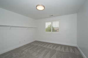 Spare room with carpet floors and baseboards