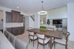 Dining area featuring recessed lighting, light wood finished floors, and stairway