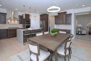 Dining space with light wood-type flooring and recessed lighting