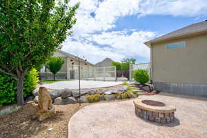 View of patio / terrace with a fire pit and a gate