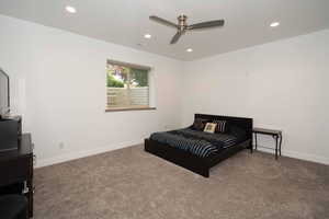 Carpeted bedroom with recessed lighting and a ceiling fan