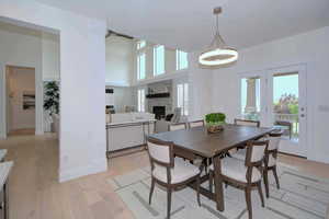 Dining space with a fireplace and light wood finished floors