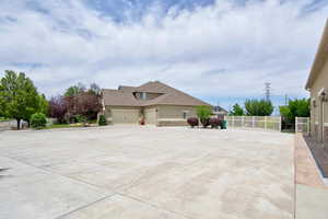 View of property exterior featuring driveway, stucco siding, and stone siding