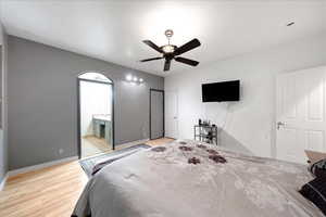 Bedroom with light wood finished floors and a ceiling fan