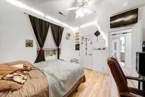Bedroom with light wood-style floors and a ceiling fan