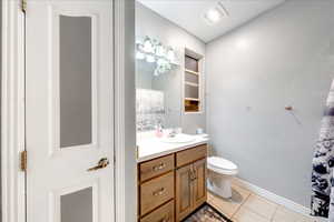 Bathroom featuring light tile patterned flooring, a shower with shower curtain, and vanity
