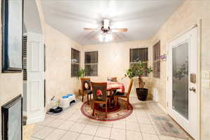 Dining room with light tile patterned floors and ceiling fan