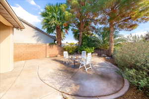Fenced backyard with a patio area and outdoor dining area
