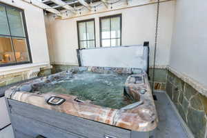 View of patio featuring a hot tub