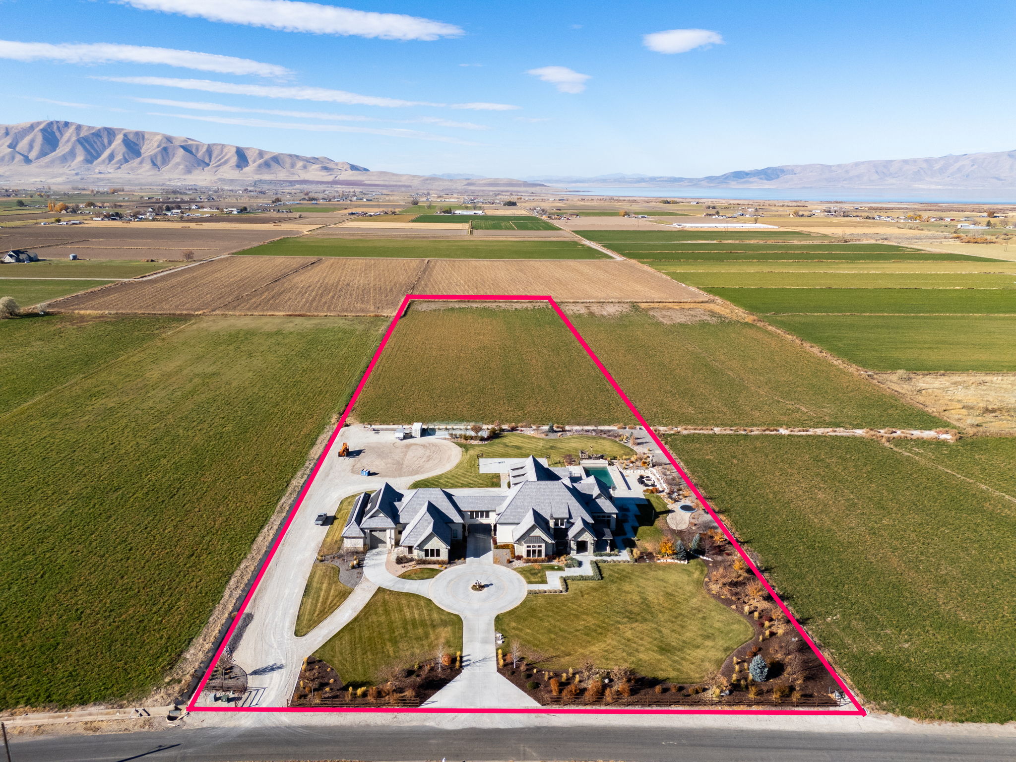 Overview of rural landscape with property boundaries highlighted, a mountain backdrop, and abundant farmland