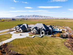 Aerial view of sparsely populated area featuring a mountain backdrop and farmland