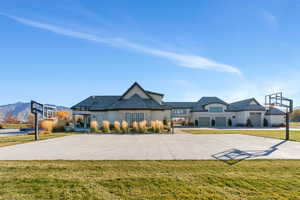 View of basketball court featuring basketball hoop and a yard