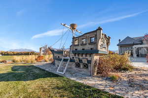 Rear view of property featuring a yard