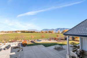 View of patio / terrace with a mountain view and an outdoor fire pit