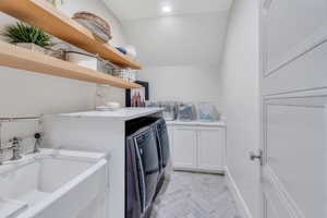 Laundry area with separate washer and dryer and cabinet space
