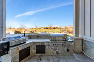 View of patio / terrace featuring a view of countryside and exterior kitchen