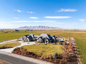 Aerial view of sparsely populated area featuring a mountain backdrop and farmland