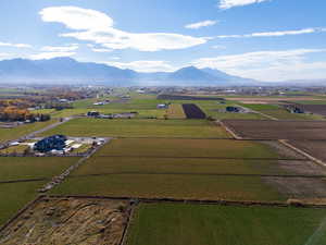 Overview of rural landscape featuring a mountainous background and abundant farmland
