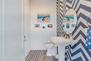 Bathroom featuring toilet and baseboards