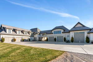 View of front of house featuring driveway and a front lawn