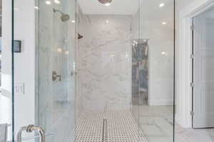 Bathroom with a marble finish shower