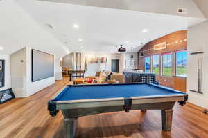 Rec room featuring brick wall, lofted ceiling, billiards, recessed lighting, and a textured ceiling