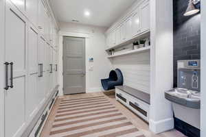 Mudroom featuring light wood-style floors and recessed lighting