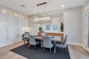 Dining room featuring light wood-type flooring and recessed lighting