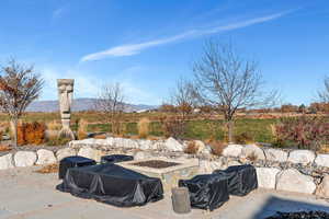 View of patio / terrace with a fire pit and a mountain view