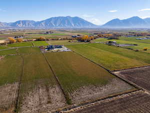 Overview of rural landscape with large plots for crops and a mountain backdrop