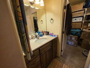 Bathroom with vanity and curtained shower