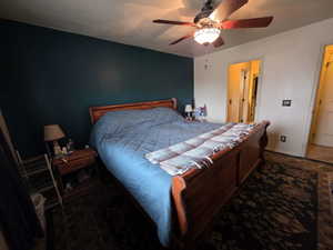 Bedroom with a ceiling fan and baseboards