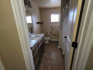 Bathroom featuring vanity, curtained shower, and dark tile patterned floors
