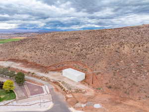 Aerial view of property and surrounding area with a mountain backdrop